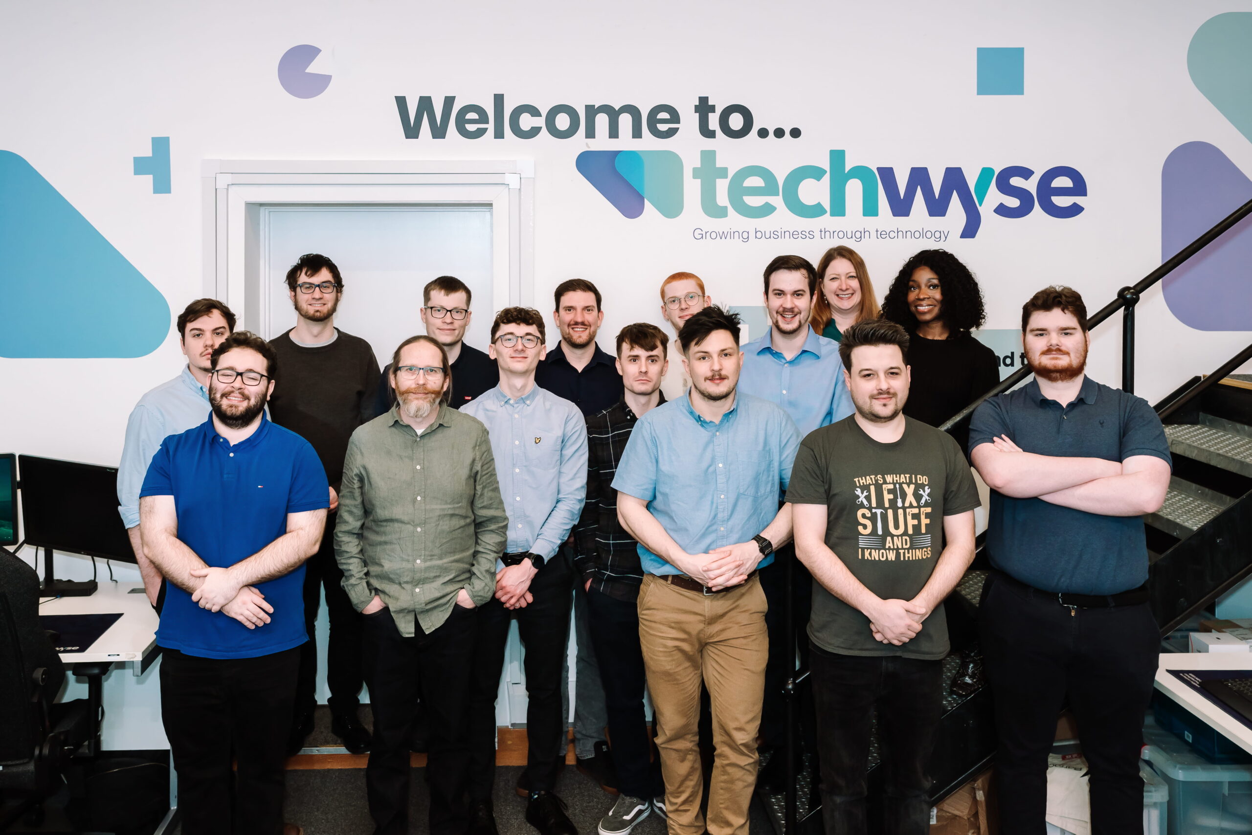TechWyse team pose for photo in their office after achieving Assurix Trustmark accreditation.
