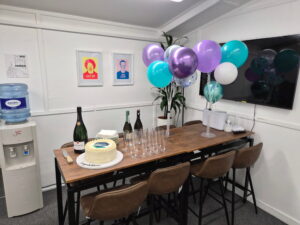 A Table with Champagne Glasses, Cake and Champagne Bottles on it